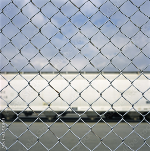 Train car through a chain link fence