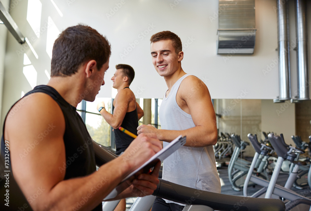 men exercising on treadmill in gym men exercising on treadmill in gym