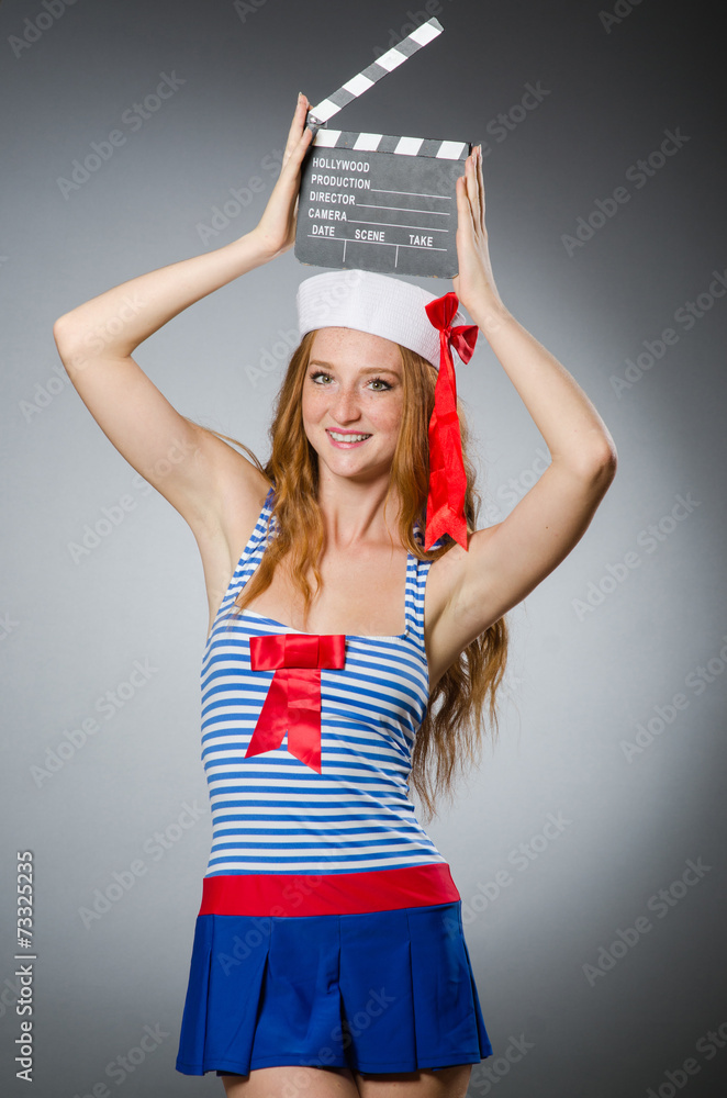 Young woman sailor with movie board Young woman sailor with movie board