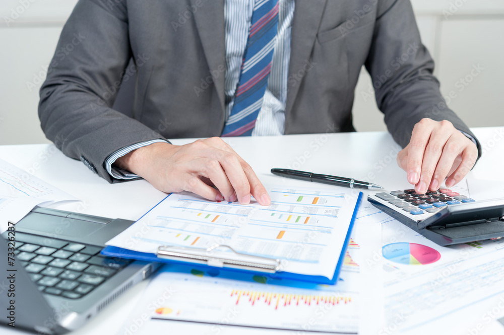 Businessman using calculator analyze report Businessman using calculator analyze report