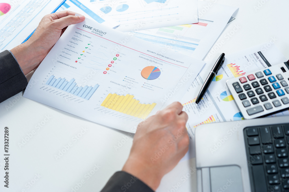 Businessman analyzing report Businessman analyzing report