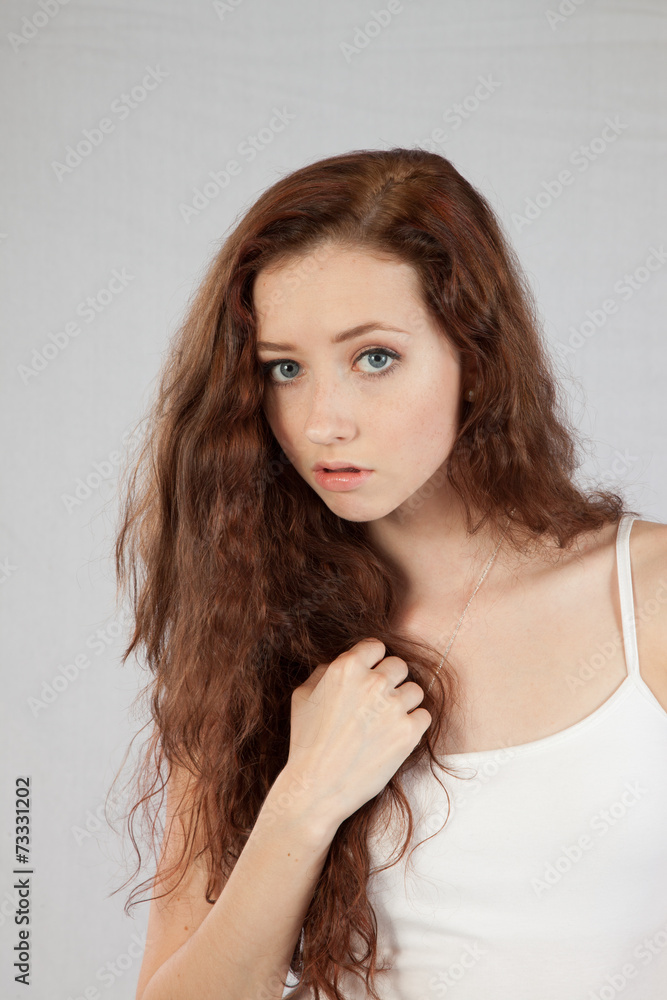 Woman with long hair looking thoughtfully at the camera Woman with long hair looking thoughtfully at the camera