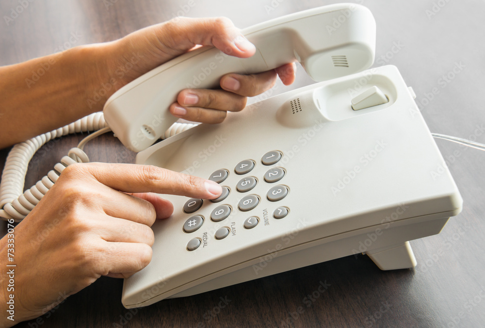Female hand holding up the phone Female hand holding up the phone