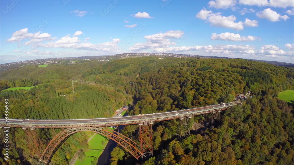 Flying along side old steel bridge, railroad train road aerial
