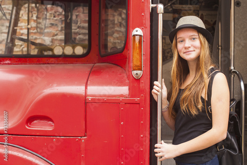Young cute girl in hat near the truck.