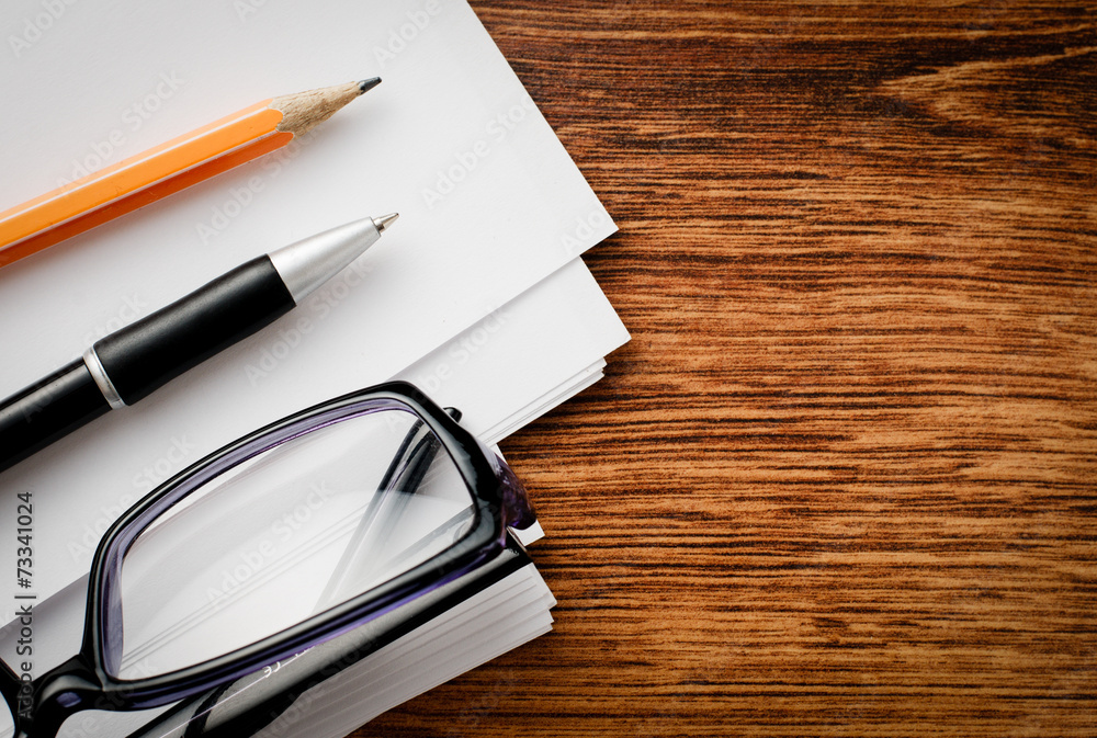 Fototapeta premium Conceptual Supplies and Glasses on Wooden Table