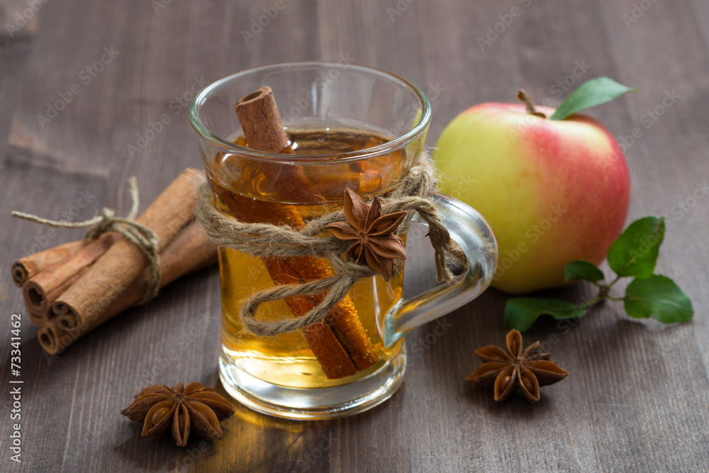spiced apple cider and spices on a wooden table spiced apple cider and spices on a wooden table