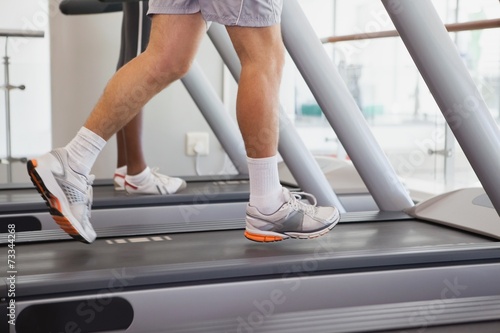 Fit people running on treadmills