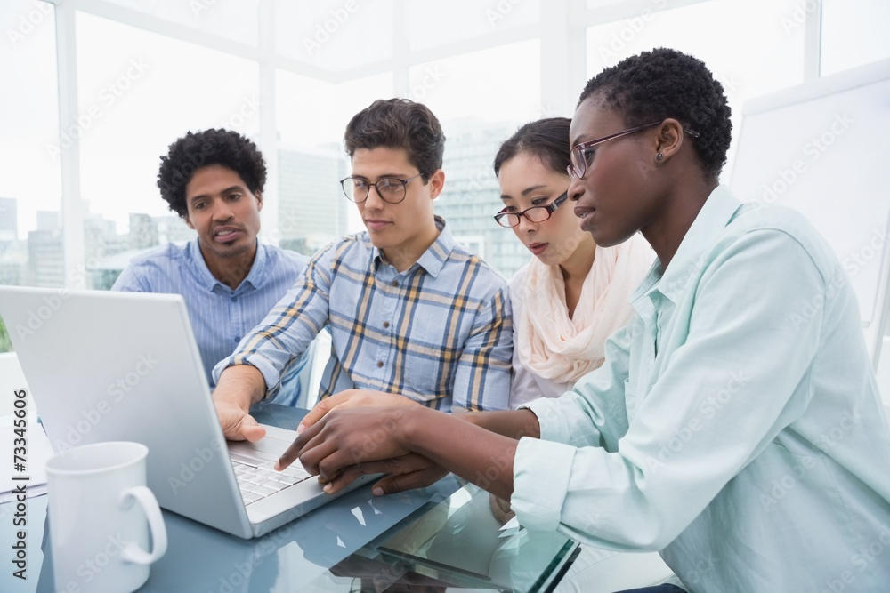 Casual business team having a meeting using laptop Casual business team having a meeting using laptop