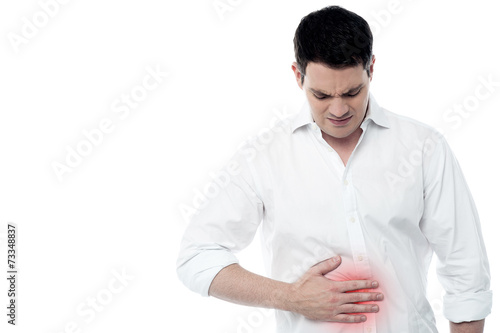 Young man with strong stomach pain photo