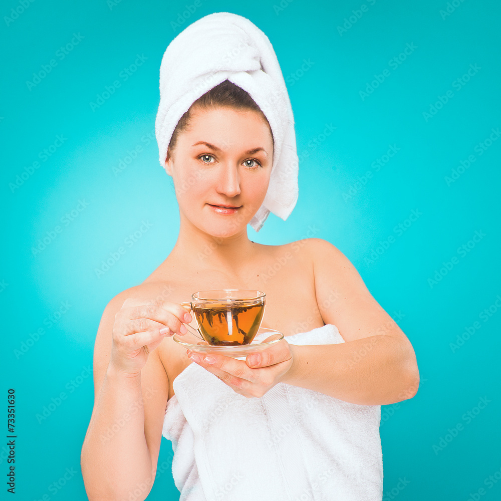 Spa salon. Woman in towel with cup of tea in her hand Spa salon. Woman in towel with cup of tea in her hand