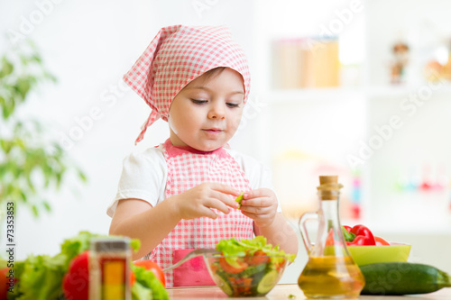 cook kid girl preparing veg...
