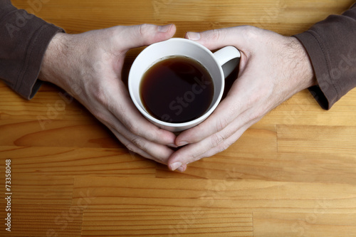 Man holding cup of tea in hands