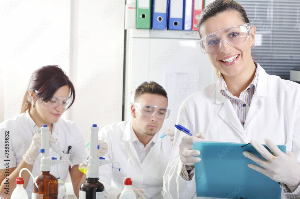 Attractive young PhD students scientists observing in the labora Attractive young PhD students scientists observing in the labora
