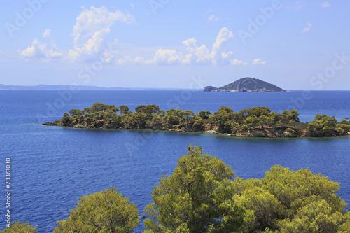 Kelyfos Island on the horizon of Aegean Sea. photo