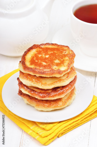 Breakfast with curd pancakes and tea