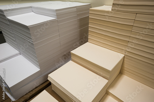 Stacks of white and beige paper