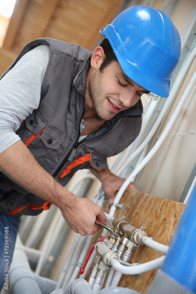 Plumber working in home being renovated Plumber working in home being renovated