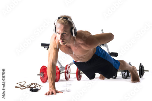 Muscular shirtless young man exercising with weights isolated