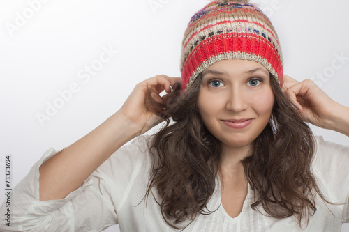 Smiling girl Holding Own knitted hat