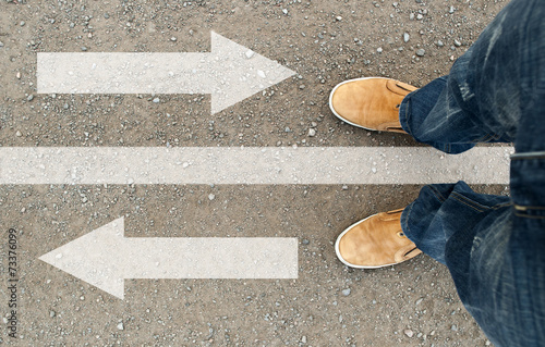 a man standing on the road. the road arrow