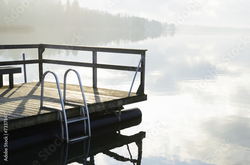 summer landscape, lake and wooden jetty photo