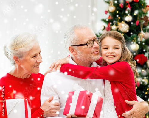 smiling family with gifts at home