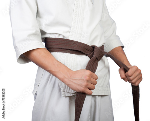White kimono belt edge in hands