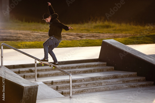 Boy doing skateboard trick in skatepark
