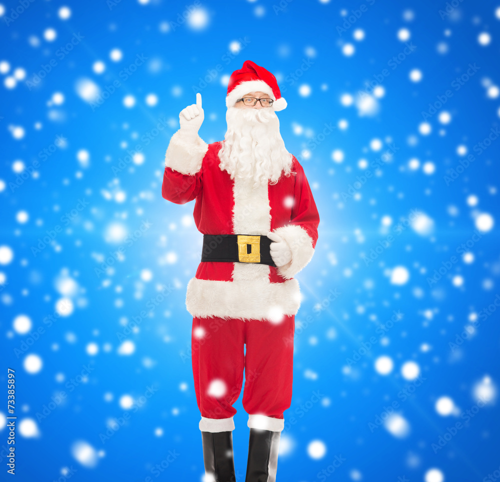 man in costume of santa claus pointing finger up man in costume of santa claus pointing finger up