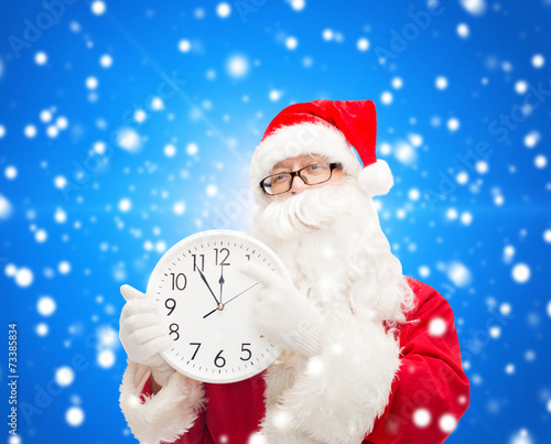 man in costume of santa claus with clock