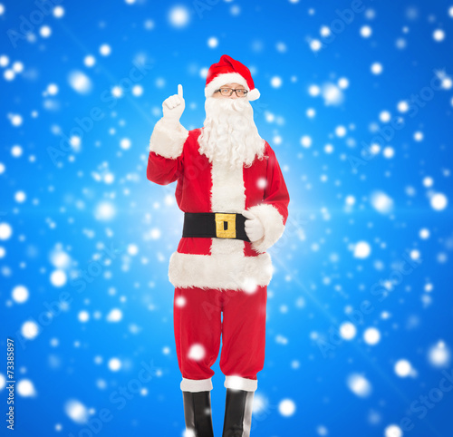 man in costume of santa claus pointing finger up © Syda Productions
