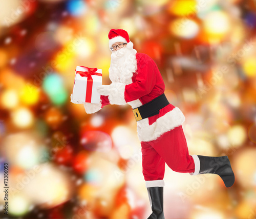 man in costume of santa claus with gift box