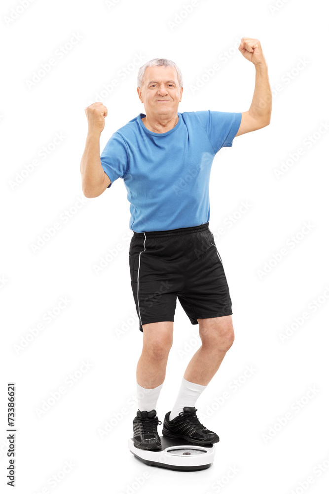 Happy senior standing on a weight scale Happy senior standing on a weight scale