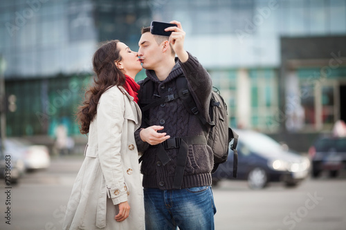 Young couple taking a selfportrait with smartphone.
