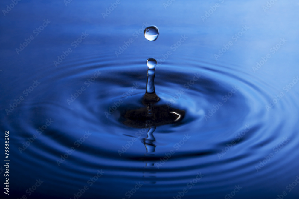 Water drop close up in blue Water drop close up in blue