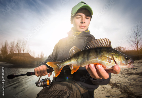 Fototapeta Naklejka Na Ścianę i Meble -  Happy angler with perch fishing trophy