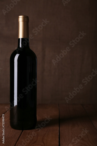 Bottle of red wine on dark background