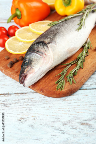 Fresh raw fish and food ingredients on table