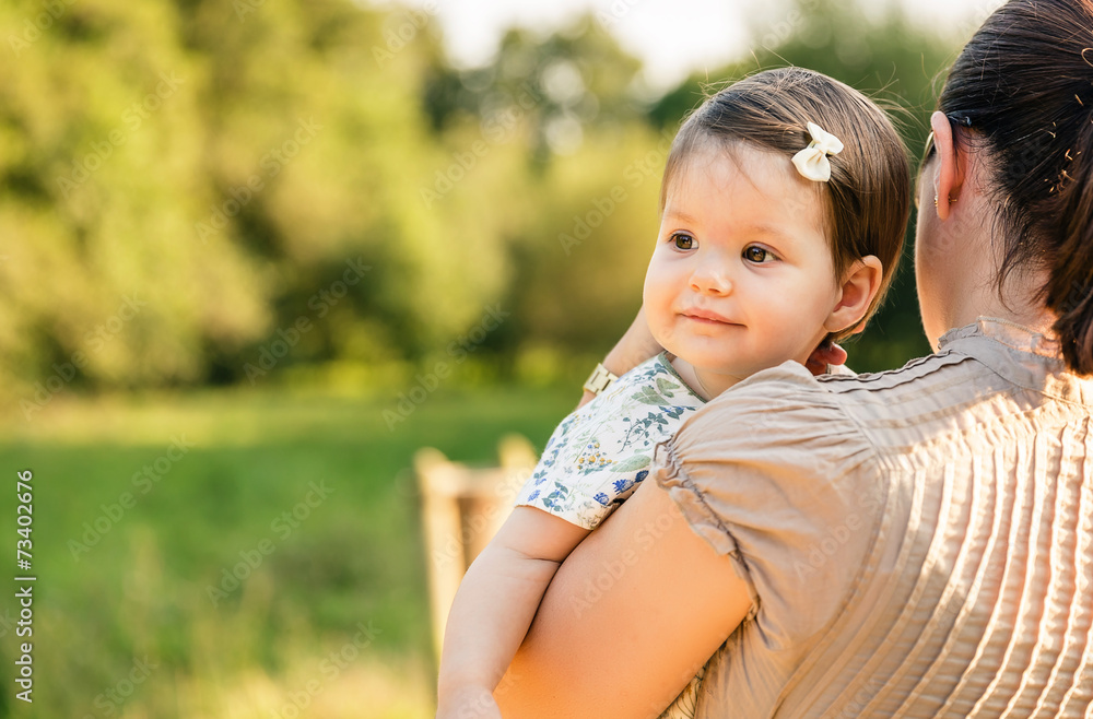 Back view of mother holding baby girl in her arms Stock Photo Adobe Stock