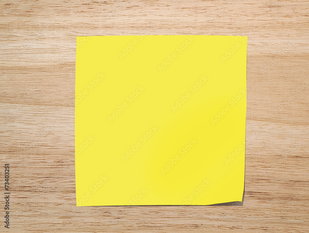 yellow paper note on Texture of wood background closeup yellow paper note on Texture of wood background closeup