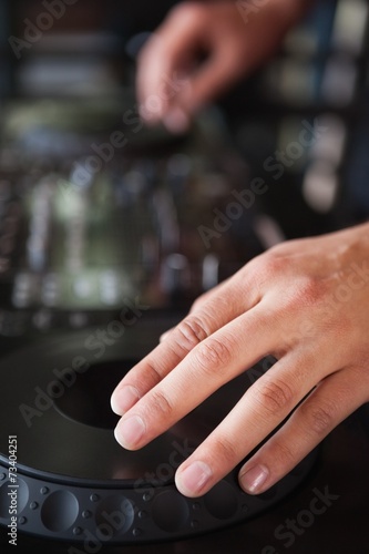 Close up of hands spinning the decks