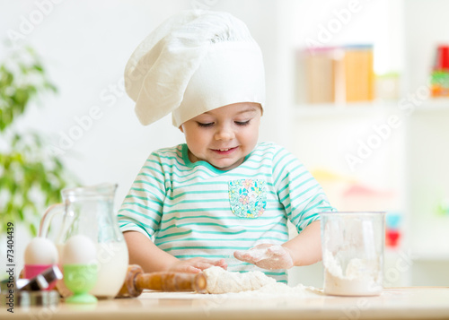 smiling baker kid girl in c...