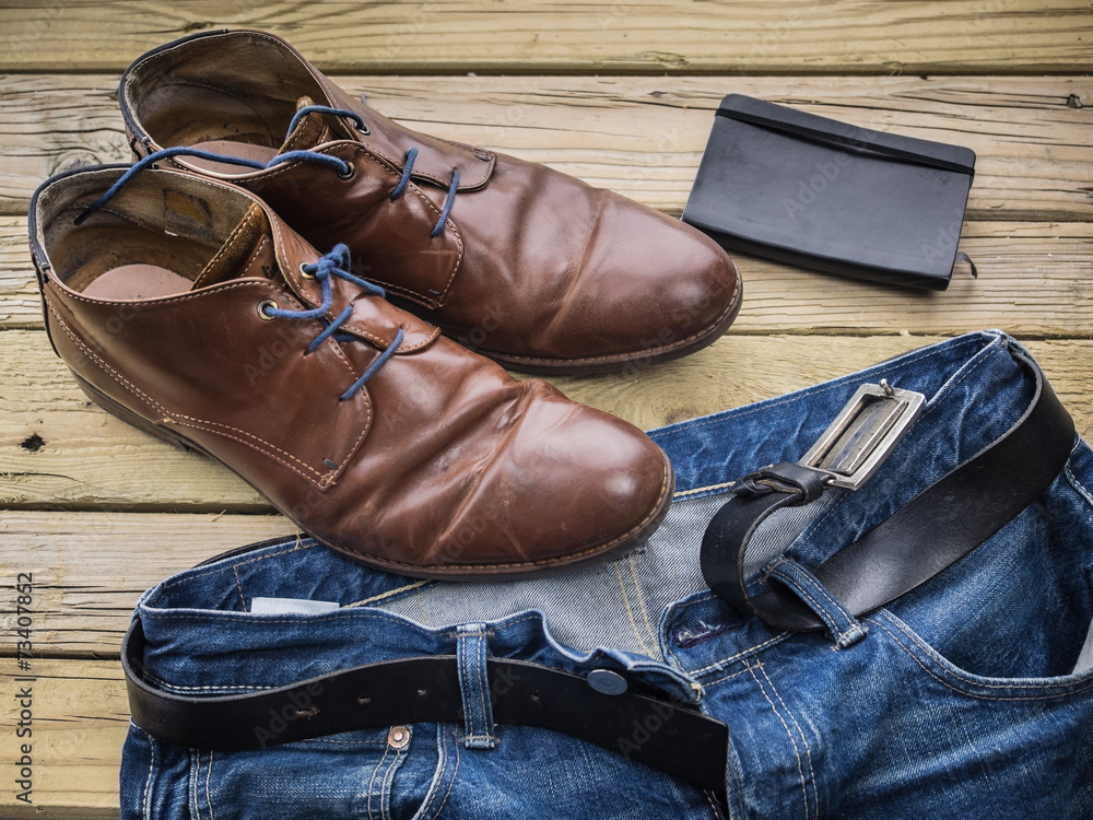 detail of blue jeans with black leather belt brown shoes and d detail of blue jeans with black leather belt brown shoes and d