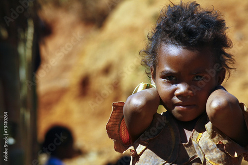 Bild auf Leinwand Poverty, portrait of a poor little African girl lost in deep tho