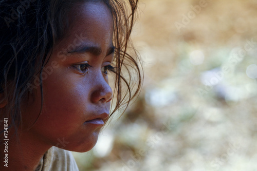 Poverty, portrait of a poor little African girl lost in deep tho