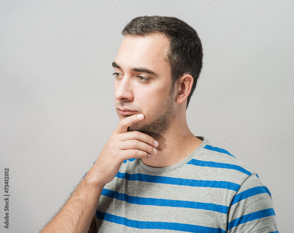 Depressed young man holding head in hands Depressed young man holding head in hands