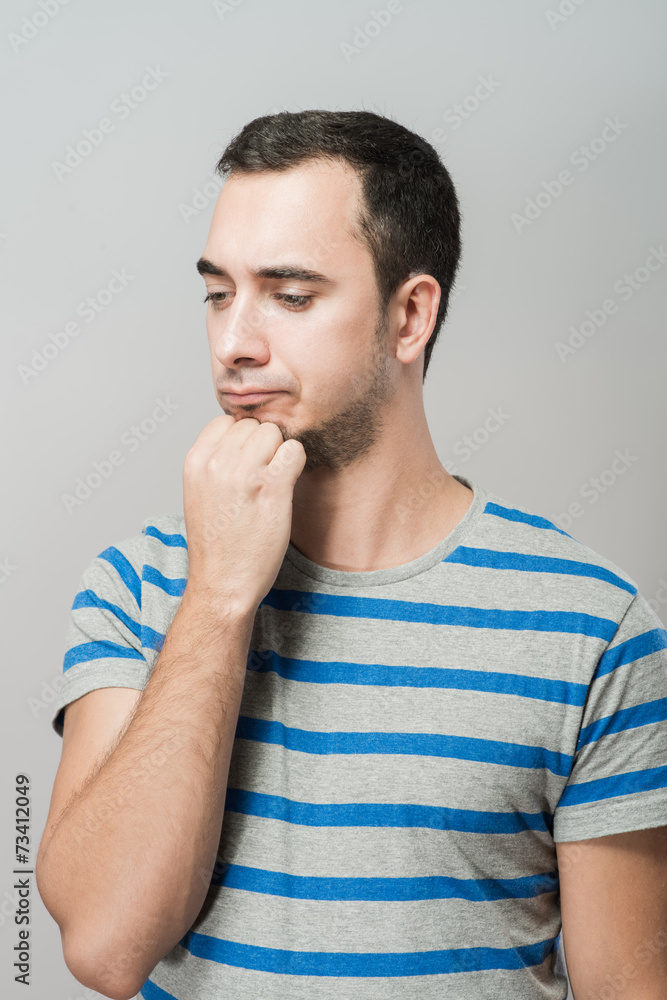 Depressed young man holding head in hands Depressed young man holding head in hands