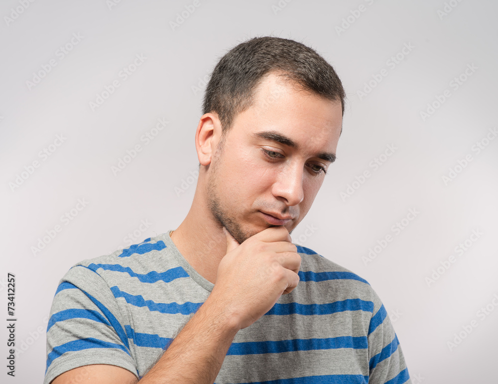 Depressed young man holding head in hands Depressed young man holding head in hands