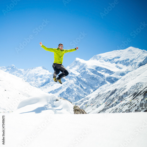 Happy man jumping success in mountains